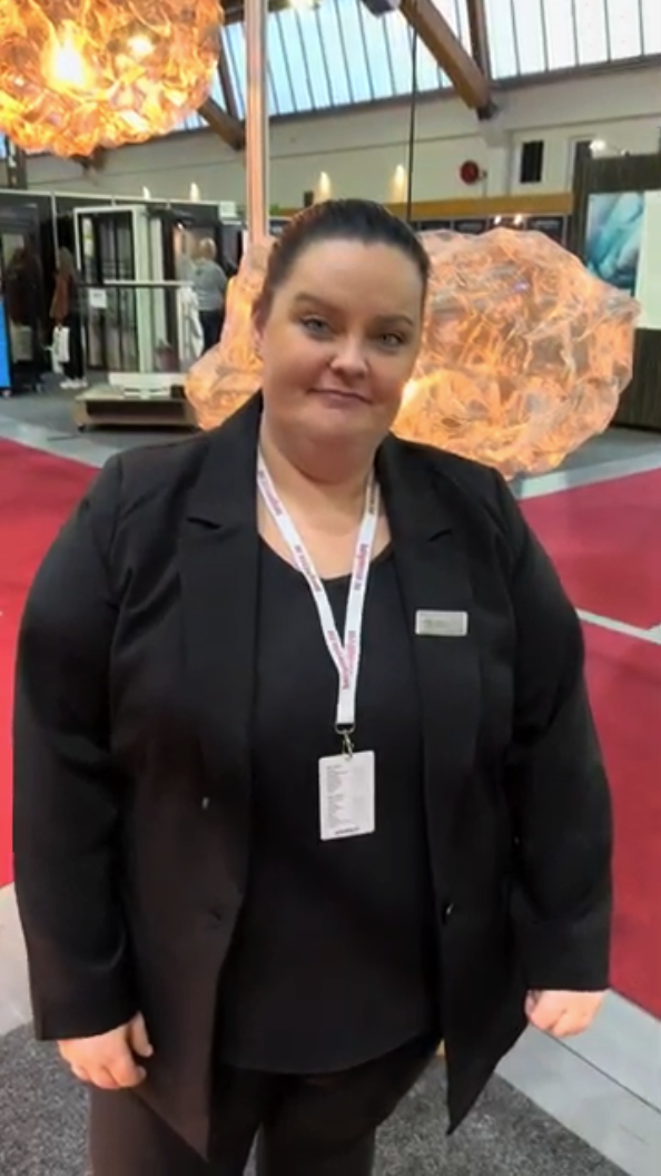 Smiling woman at an exhibition stand