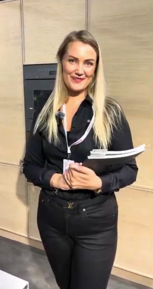 Smiling woman at an exhibition stand